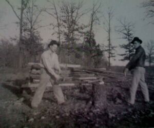 The dangerous, backbreaking work didn't end with the end of each shift. Here, Mutt and Ed VonMoss, another ground boss, cut winter wood for three families.