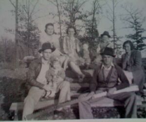Mutt, lower left, holds his only daughter, Barbara, who was known as Bob. Lovell Mantle is standing at the far right. The little boy at the center is Ed's son, Jerry VonMoss.