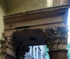 Doric columns supported a portico made of pink travertine. The frieze was decorated with a cornucopia of vegetative detail.